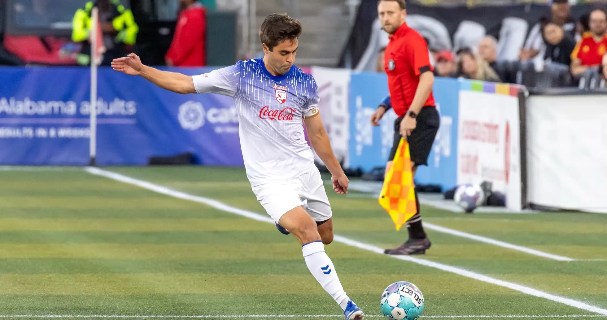 Player preparing to kick ball during match