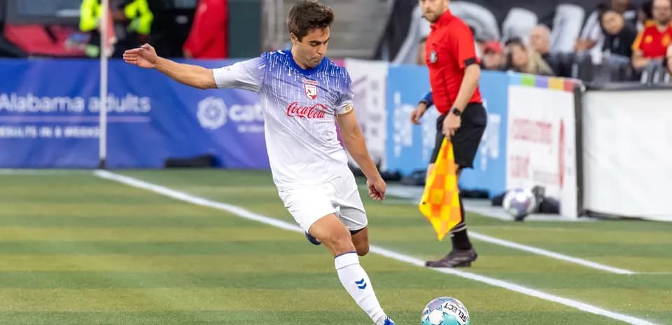 Player preparing to kick ball during match