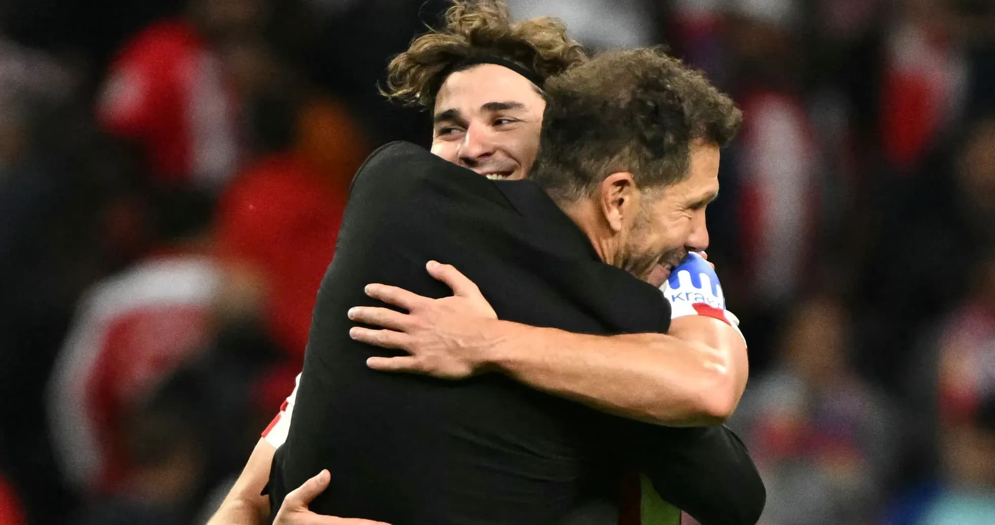 Two players embracing after a match celebration