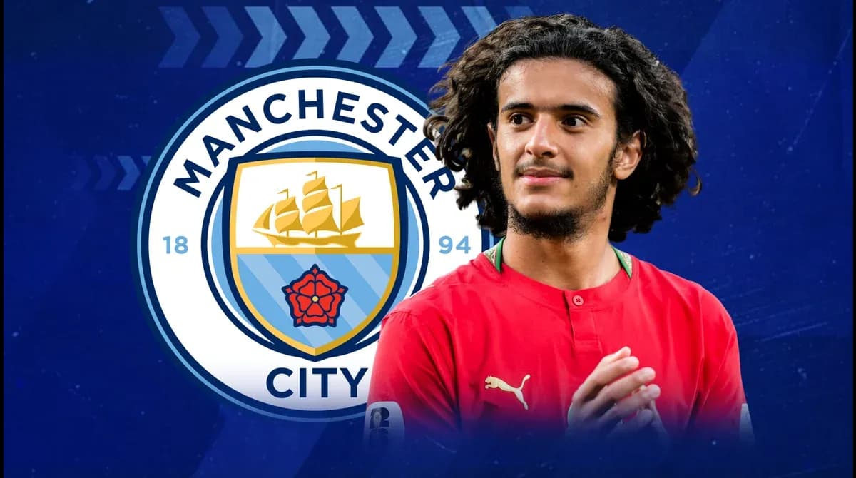 Player in red shirt with Manchester City logo background