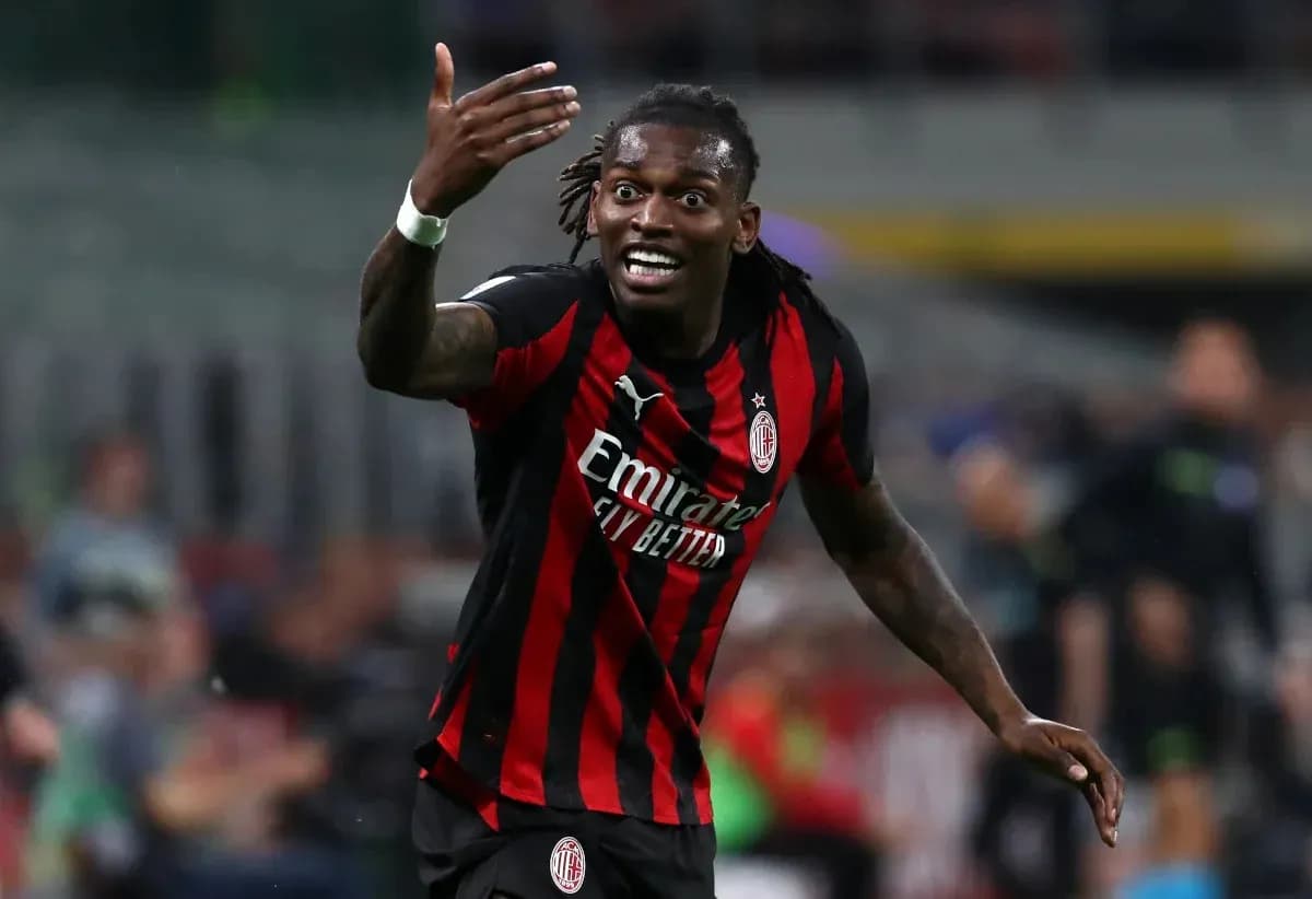 Player gesturing during a match wearing AC Milan jersey
