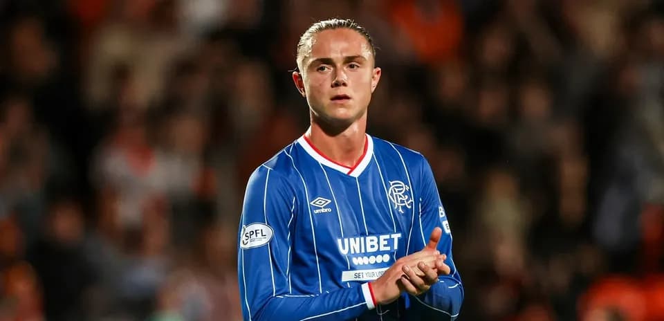 Player in blue kit clapping to fans at stadium