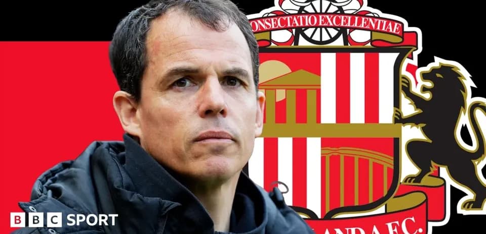 Coach in front of Sunderland AFC logo backdrop