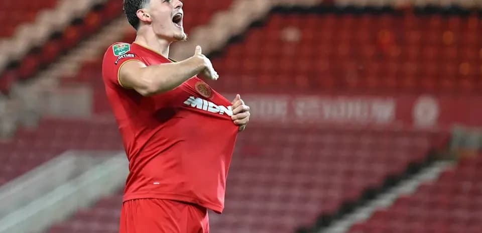 Player celebrating by lifting shirt after scoring