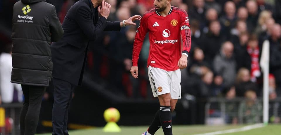 Coach discussing strategy with Manchester United player