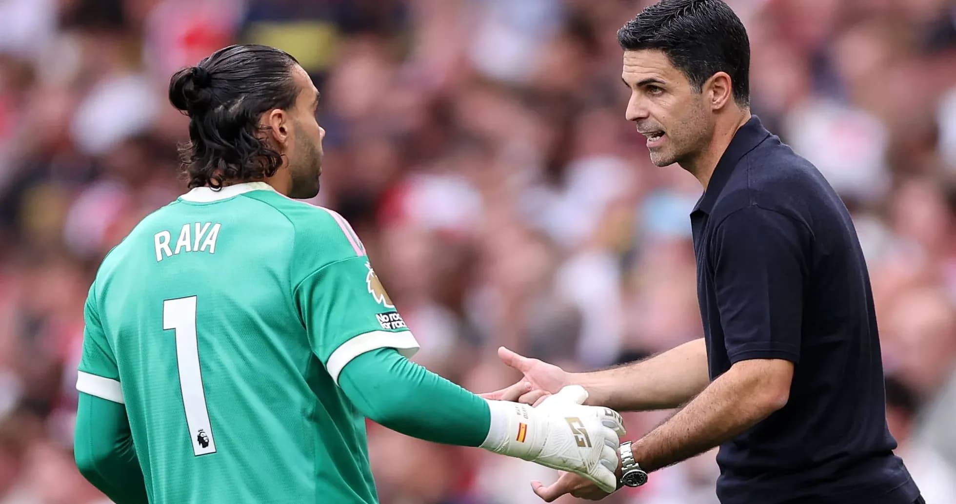 Goalkeeper and manager discussing during match