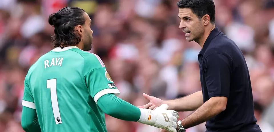 Goalkeeper and manager discussing during match