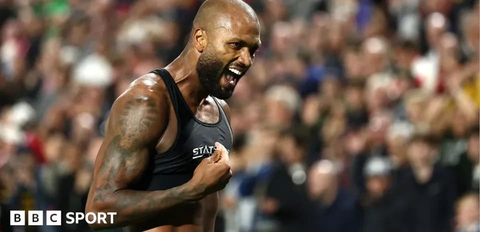 Athlete celebrating in front of cheering crowd