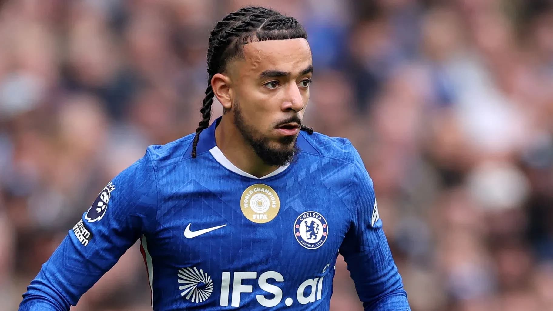 Player in blue Chelsea kit running on the field