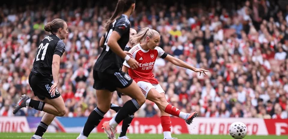 Arsenal player shooting on goal during match