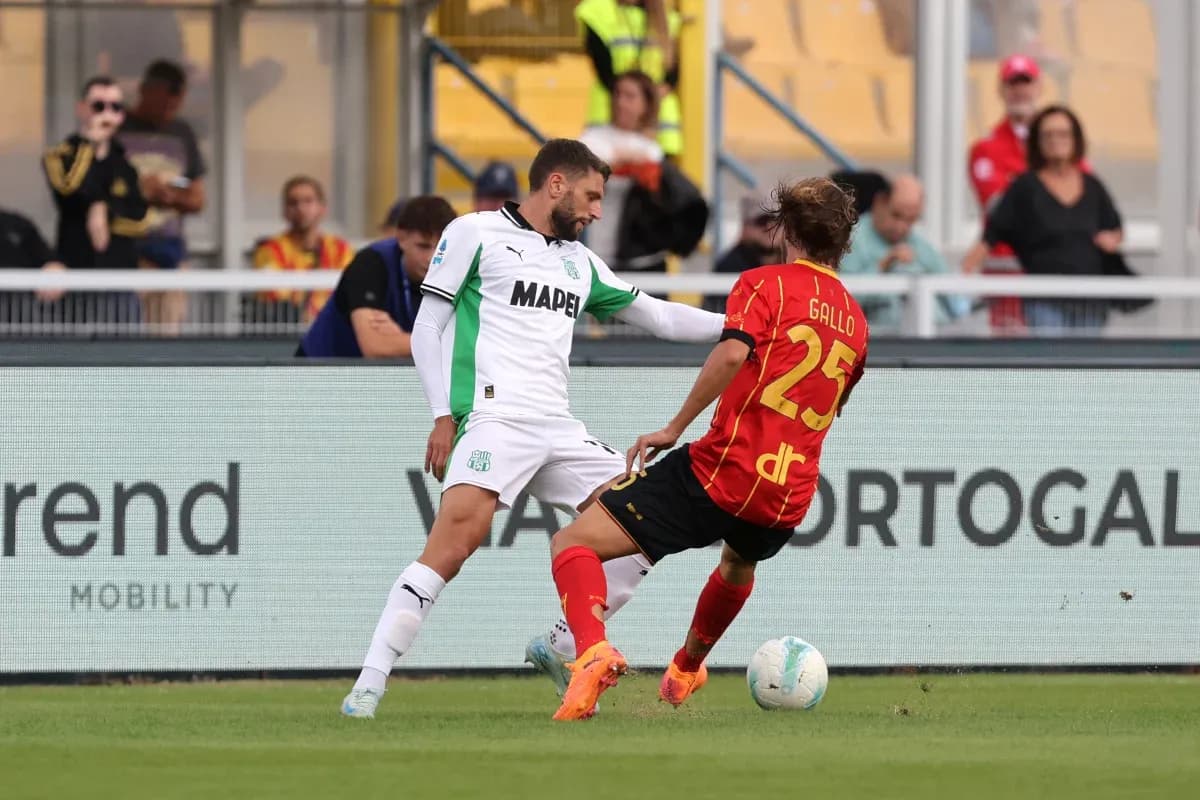 Sassuolo player challenging Lecce opponent for the ball