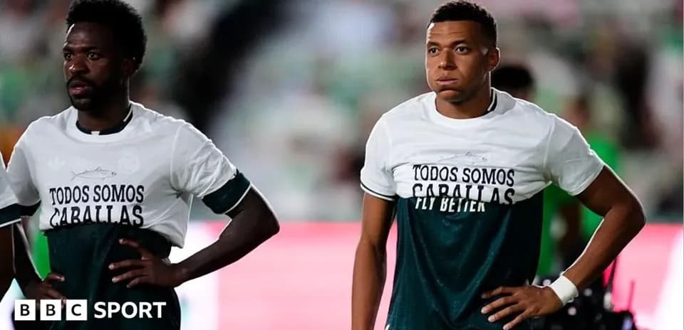Two players wearing matching shirts on the field