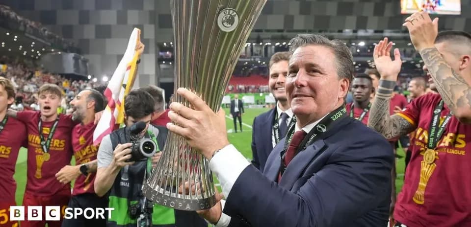 Coach holding UEFA Europa Conference League trophy with team