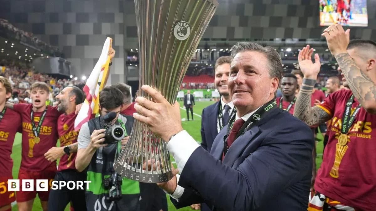 Coach holding UEFA Europa Conference League trophy with team