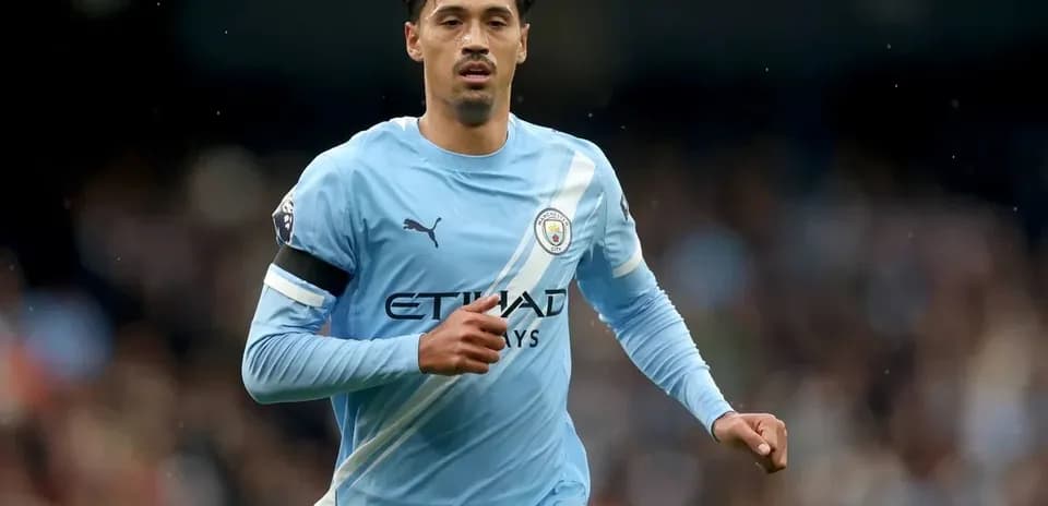 Player running on the pitch in Manchester City kit