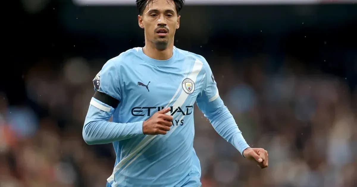 Player running on the pitch in Manchester City kit