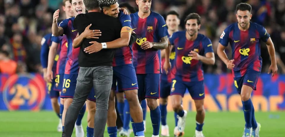 Barcelona players celebrating with the coach after victory