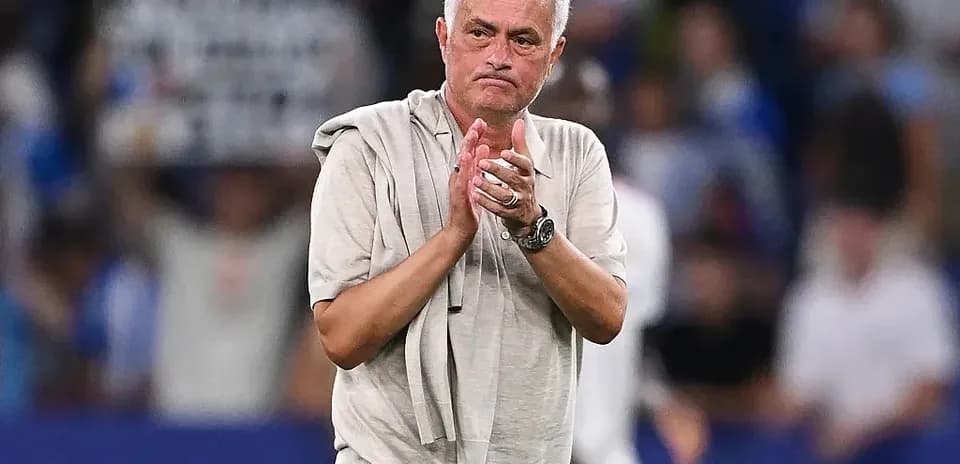 Coach applauding after a match on the pitch
