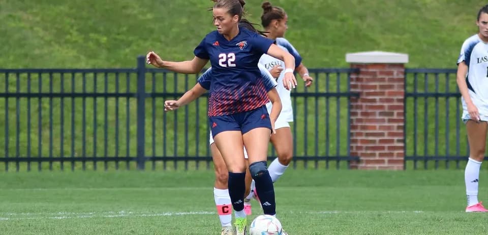 Player dribbling the ball on the soccer field