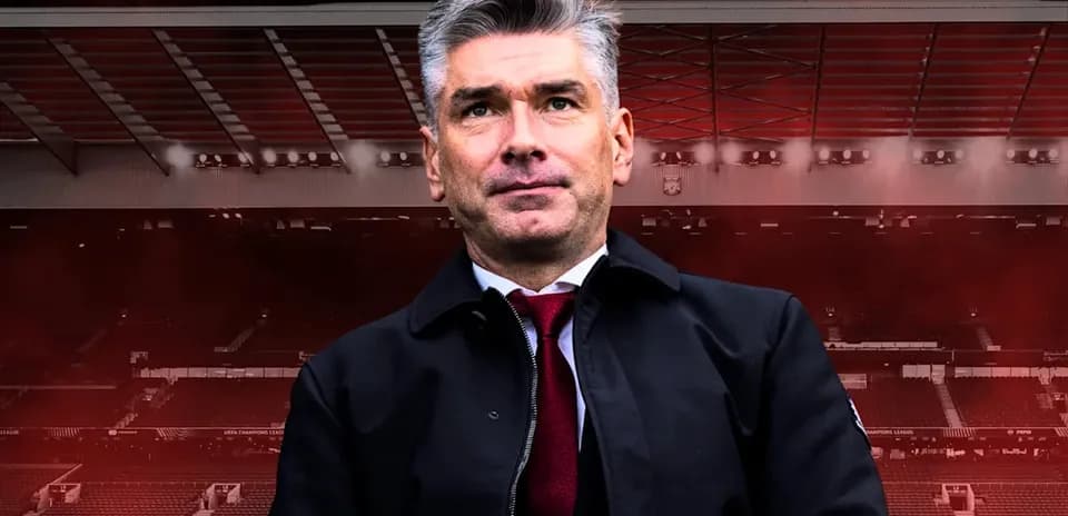 Man in suit standing in stadium setting
