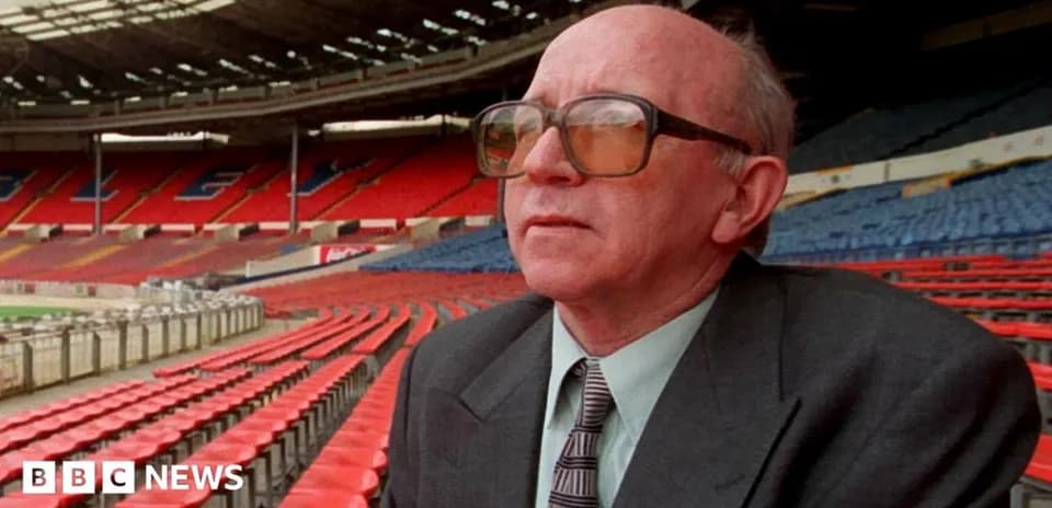 Person seated in empty stadium looking ahead