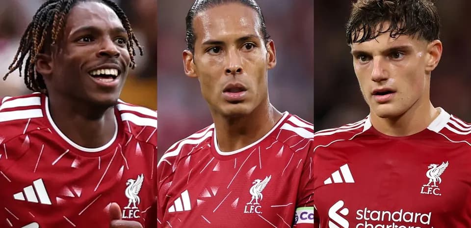 Three Liverpool players in red jerseys during match