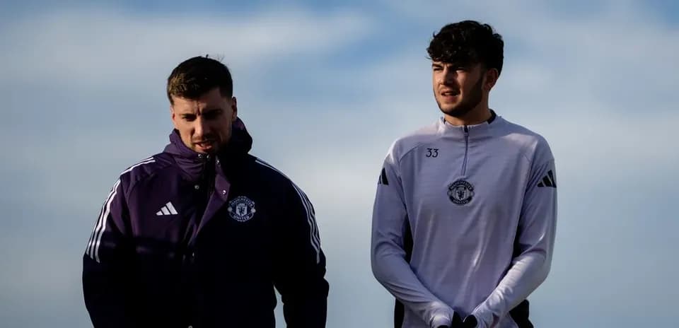 Two Manchester United players walking outdoors