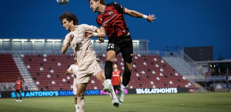 Players competing for the ball during match