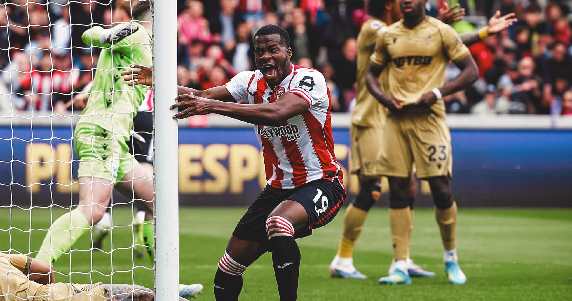 Brentford player celebrating near goal post
