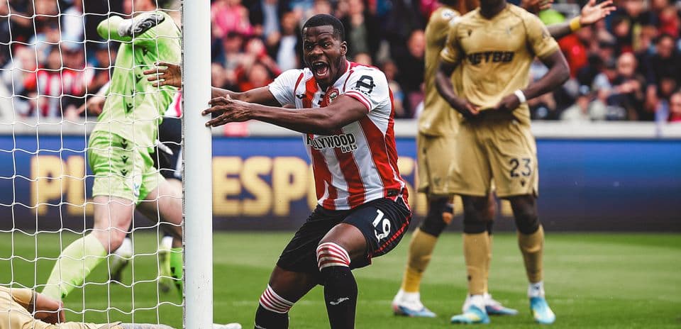 Brentford player celebrating near goal post