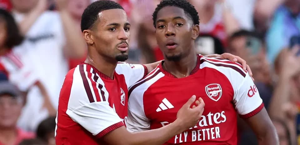Two Arsenal players celebrating after a goal