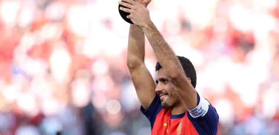 Player holding trophy aloft in celebration