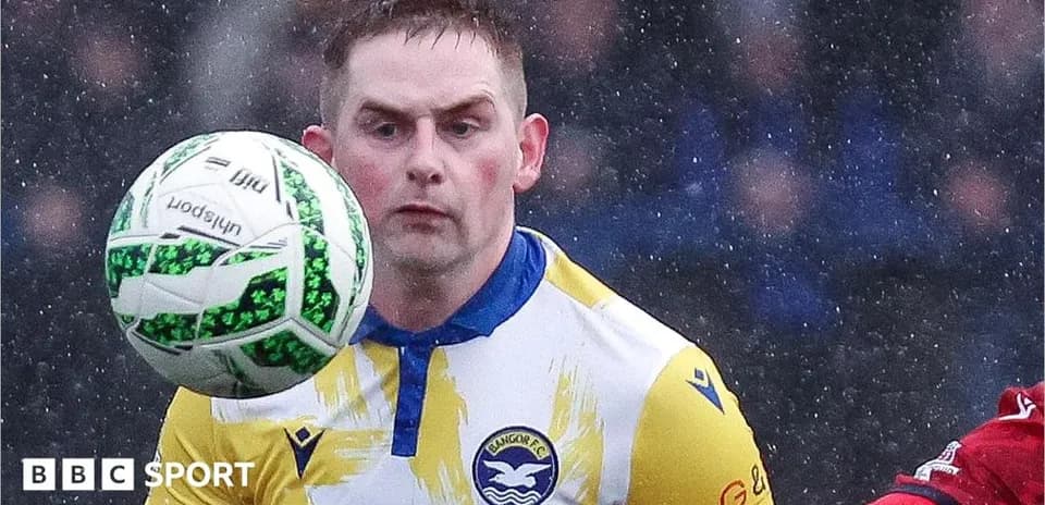 Player controlling ball during match in rainy weather