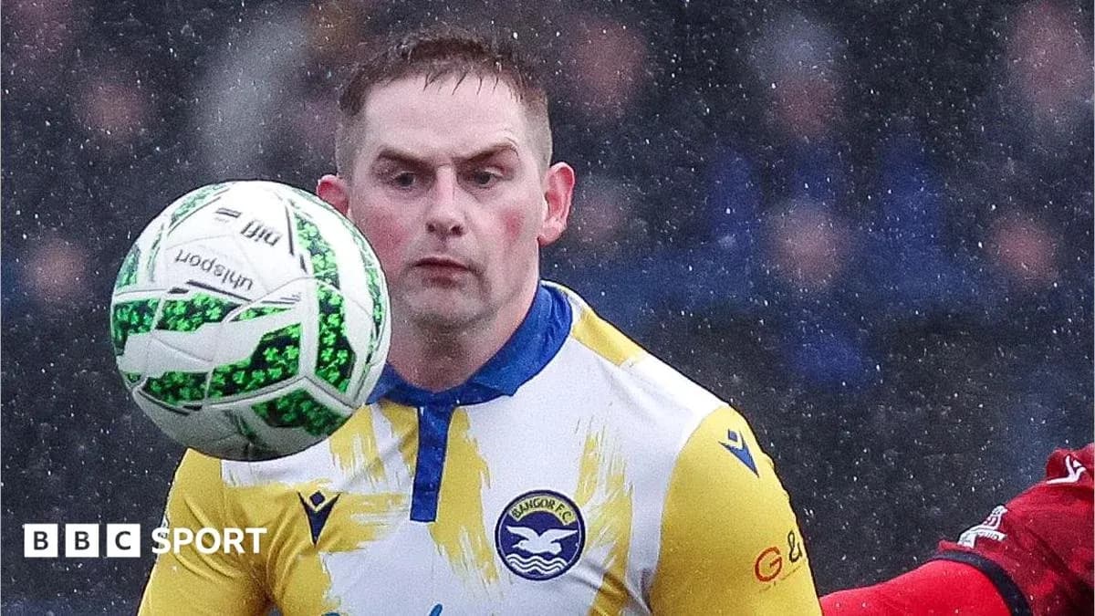 Player controlling ball during match in rainy weather