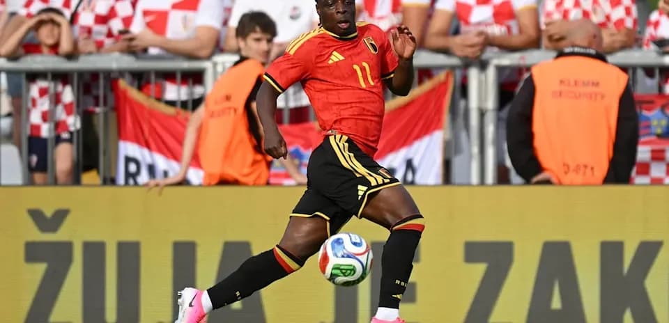 Belgian player running with ball during match