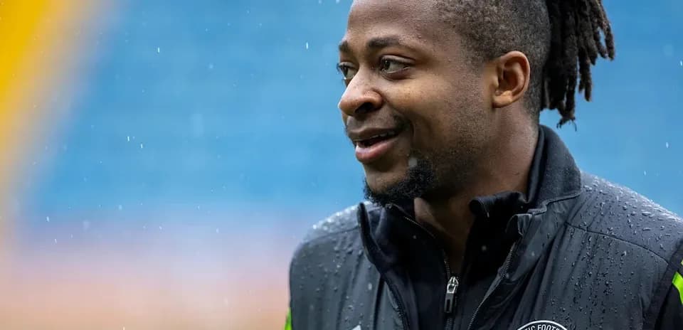 Player smiling in rain during training session