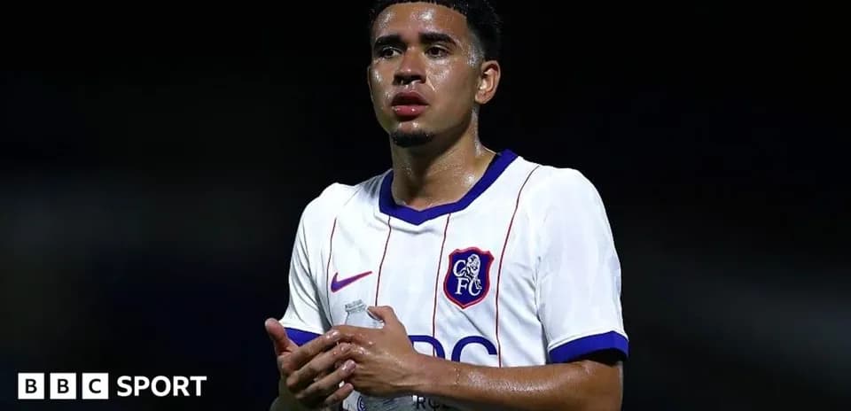 Player in white jersey holding water bottle after match