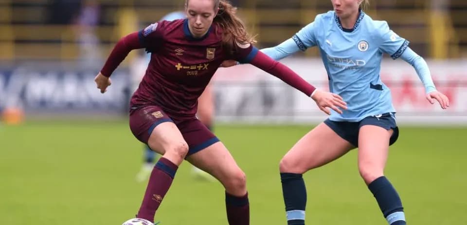 Two players contesting for the ball on field
