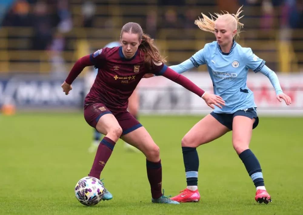 Two players contesting for the ball on field