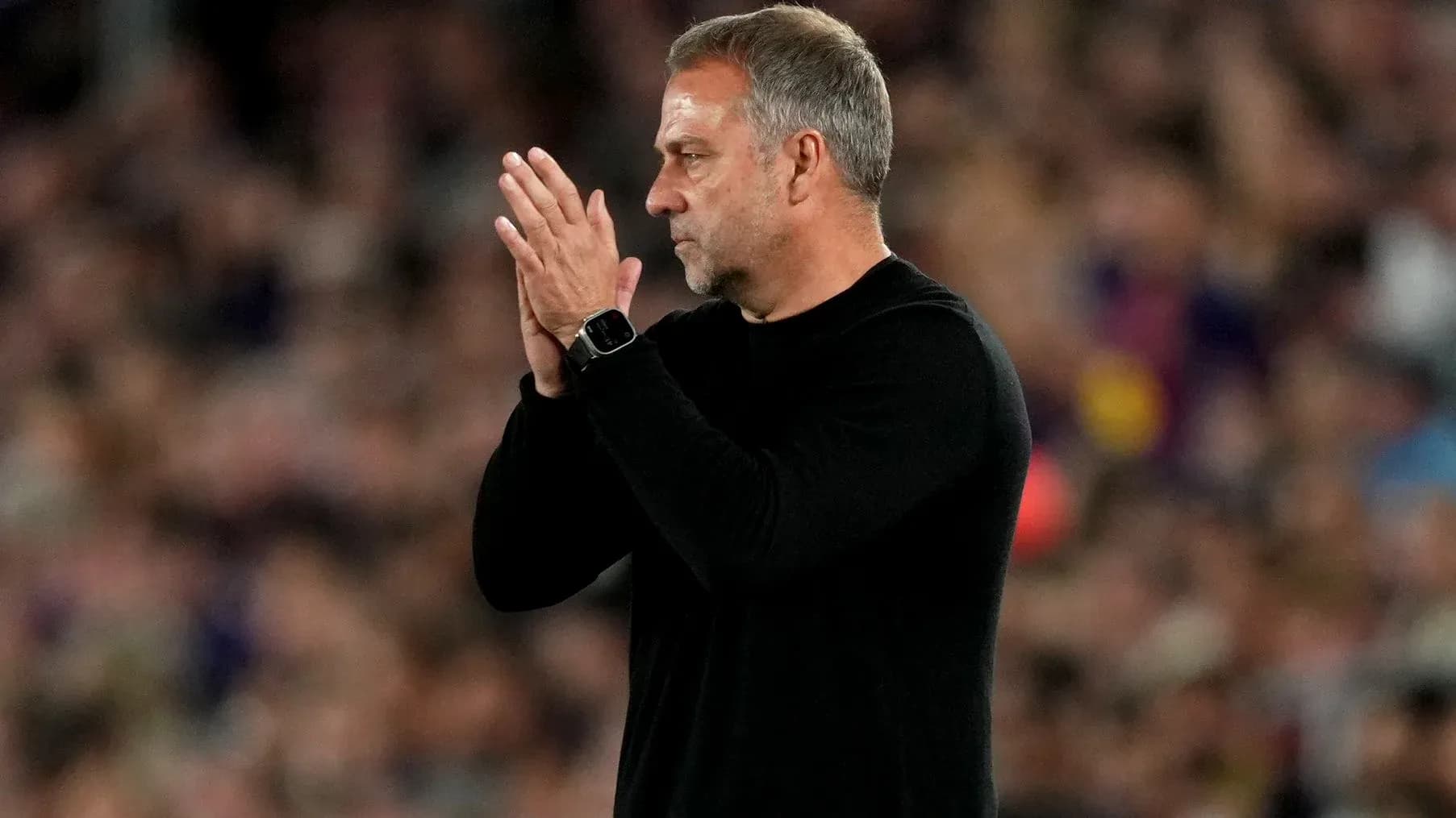 Coach applauding during a match at the stadium