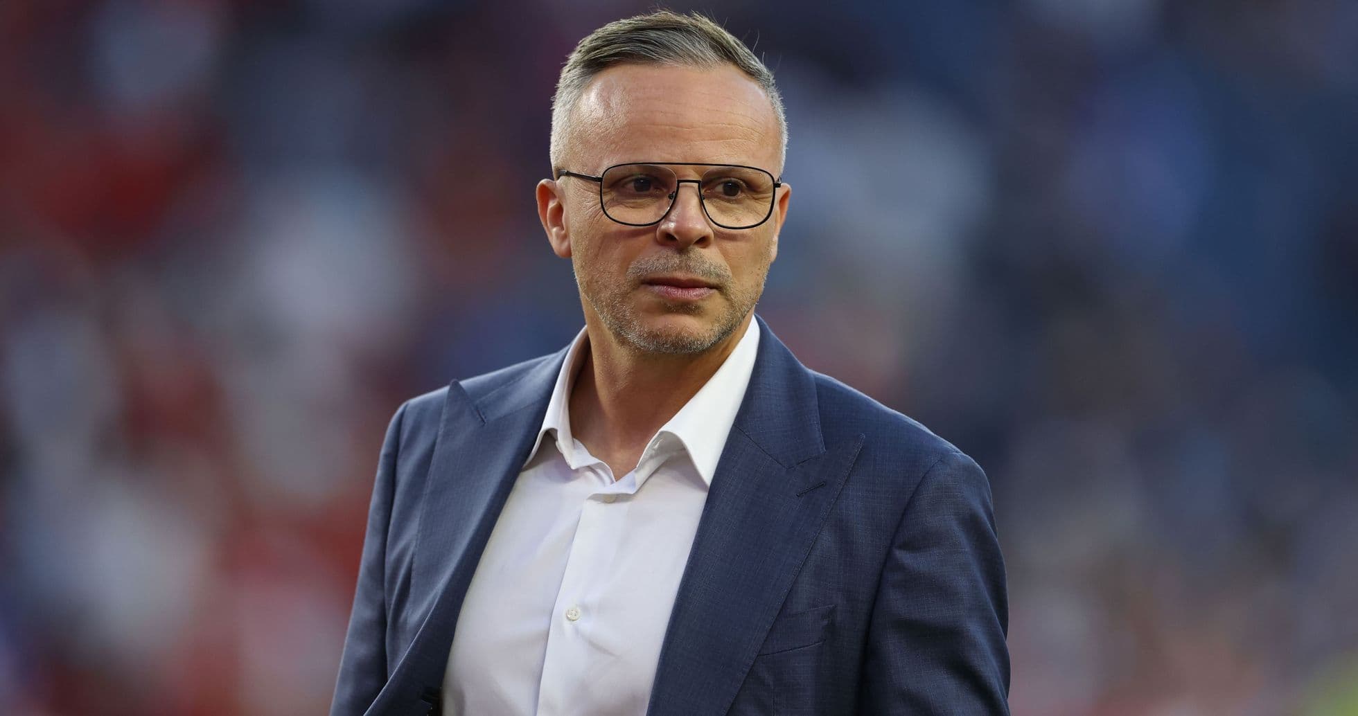 Coach in a suit on the sidelines during match