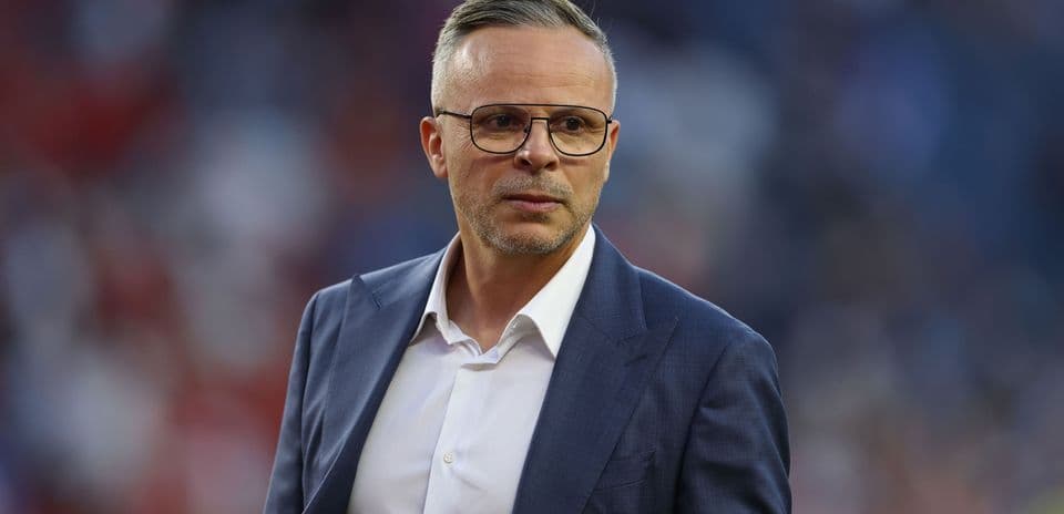 Coach in a suit on the sidelines during match