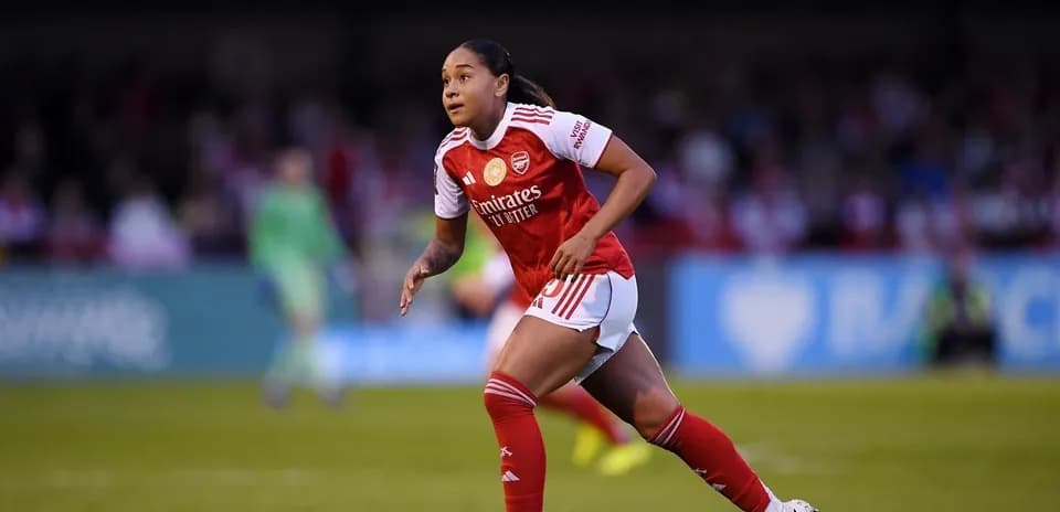 Player running on the field in Arsenal kit