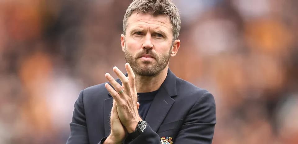 Coach clapping hands during match on sidelines
