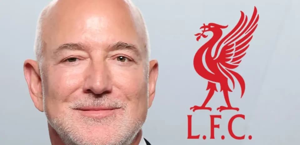 Person smiling with Liverpool FC logo in background