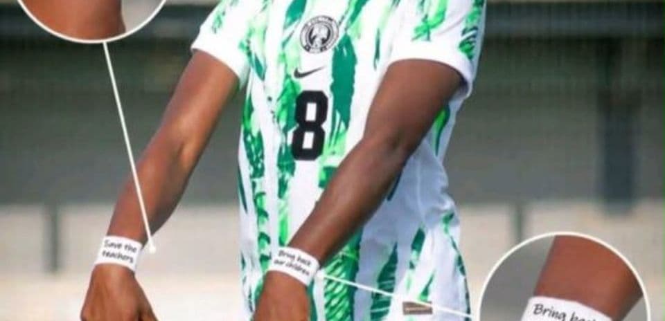 Player wearing jersey with protest messages on wrists