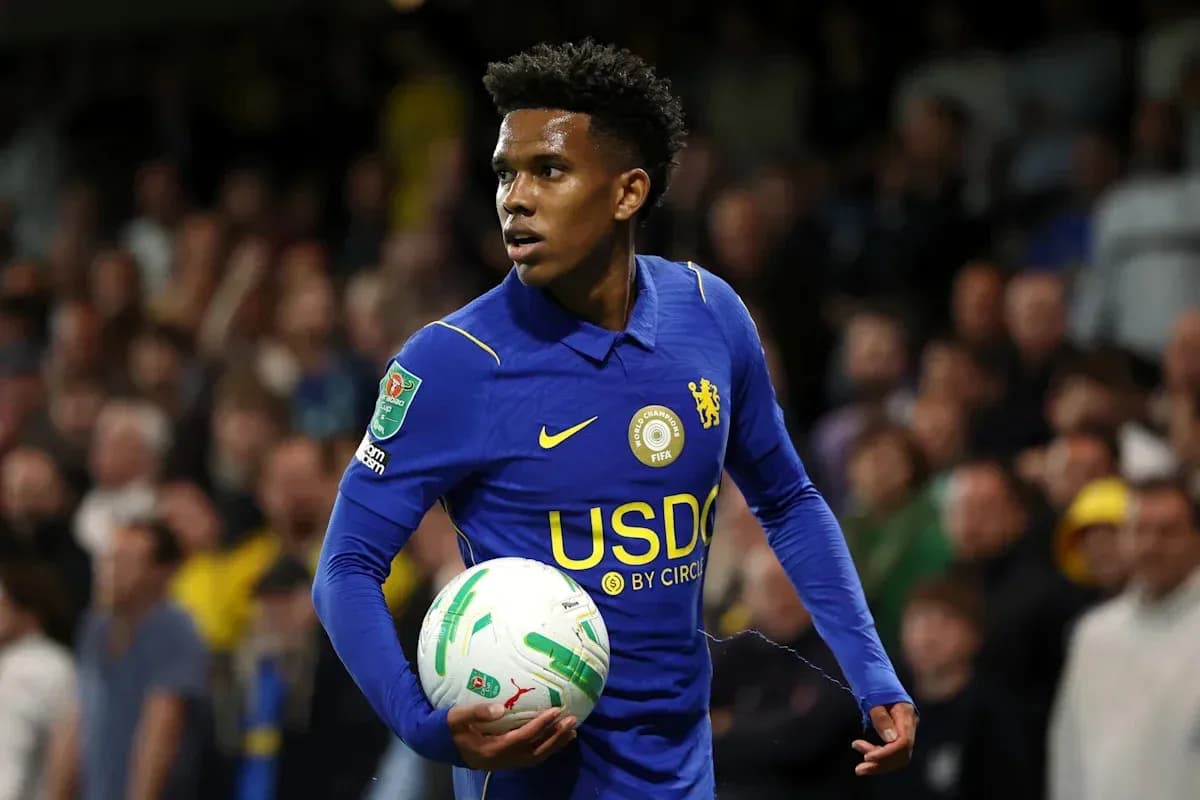 Player in blue jersey holding a football during match