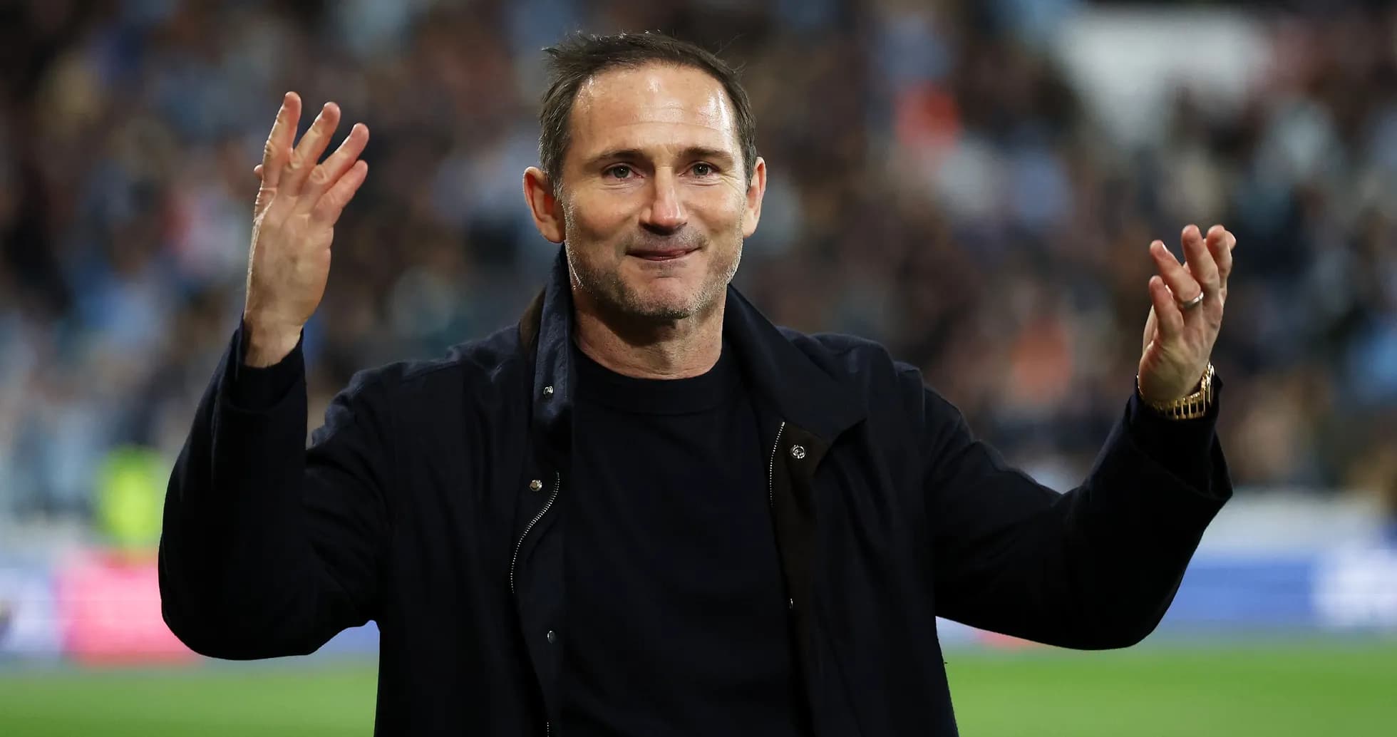 Manager gesturing to fans during match celebration