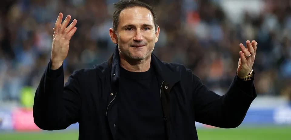 Manager gesturing to fans during match celebration
