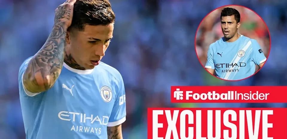 Football player in Manchester City kit looking down